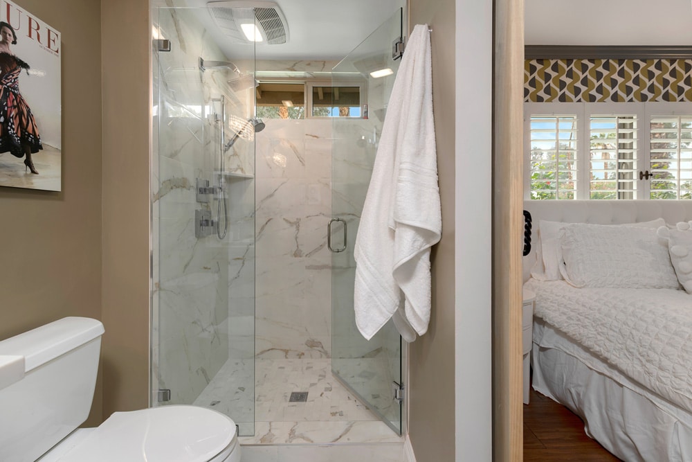 Bathtub and shower combo transformed into a beautiful and spacious walk-in shower.