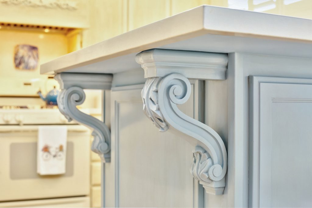 Decorative corbels and a pop of color made this breakfast bar so much more interesting!