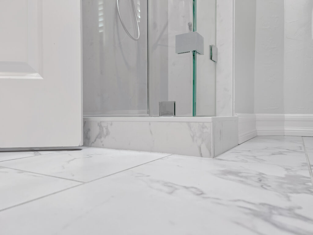 standing shower with marble floor