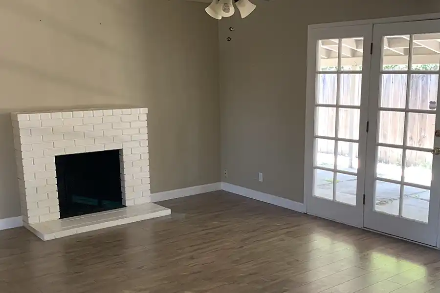 38 Living Room BEFORE James Carey in a white-neutral kitchen with happy customers
