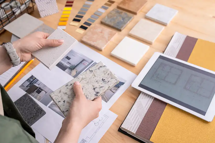 person inspecting stone tiles and other design elements