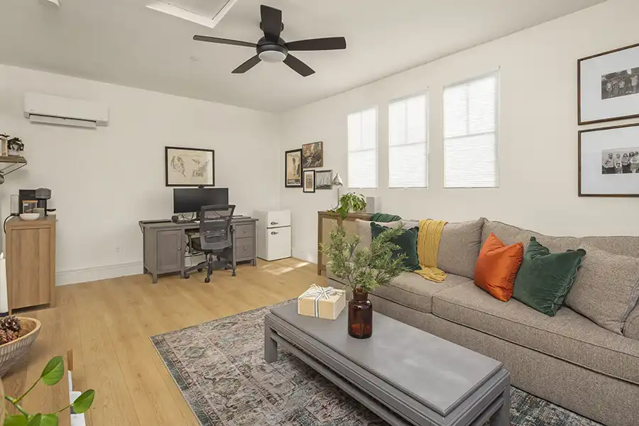 01 ARCH Cream walls, light wood plank flooring, white window coverings, mini-split hvac, light colored window coverings