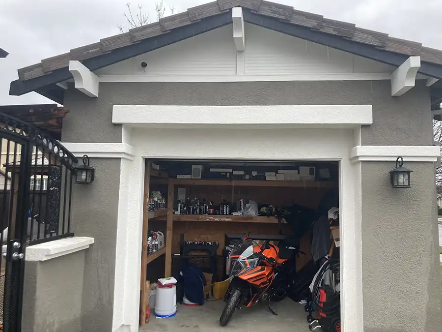 01 BEFORE ARCH IMG_1345 Exterior of garage before remodel: gray stucco with white trim