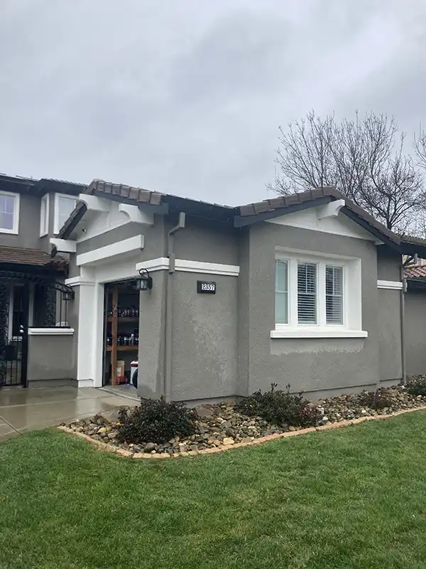 02 BEFORE ARCH IMG_1348 Exterior of garage before remodel: gray stucco with white trim