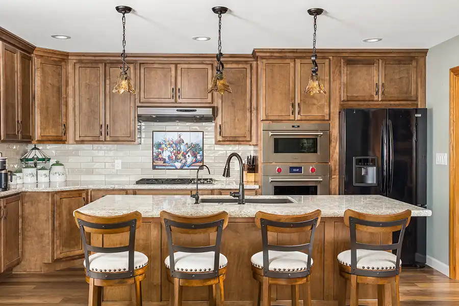 02 YellowoodPl_CareyBros1 Custom cabinetry with a clean, transitional profile, Large center island, Durable quartz or stone countertops with eased edges, Tile backsplash extending to the underside of upper cabinets, Energy-efficient appliances integrated into the cabinetry layout, task and ambient lighting with dimmable controls, Pantry storage