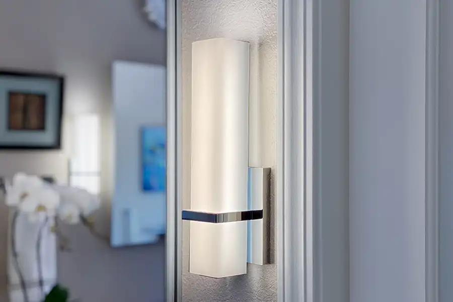 020_5558_Arlene_way15 Creamy almond walls, light-toned wood cabinets with modern hardware, light colored stone countertops with twin sinks, a soaking tub in the corner by a window, with a glass-surround shower in the opposing corner, and wood motif tile on the floors.