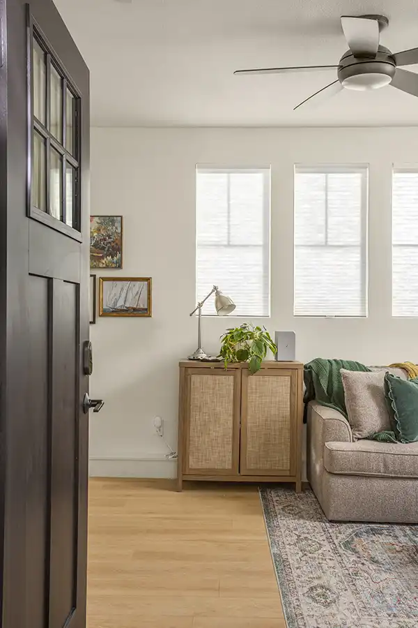 03 ARCH Cream walls, light wood plank flooring, white window coverings, mini-split hvac, light colored window coverings