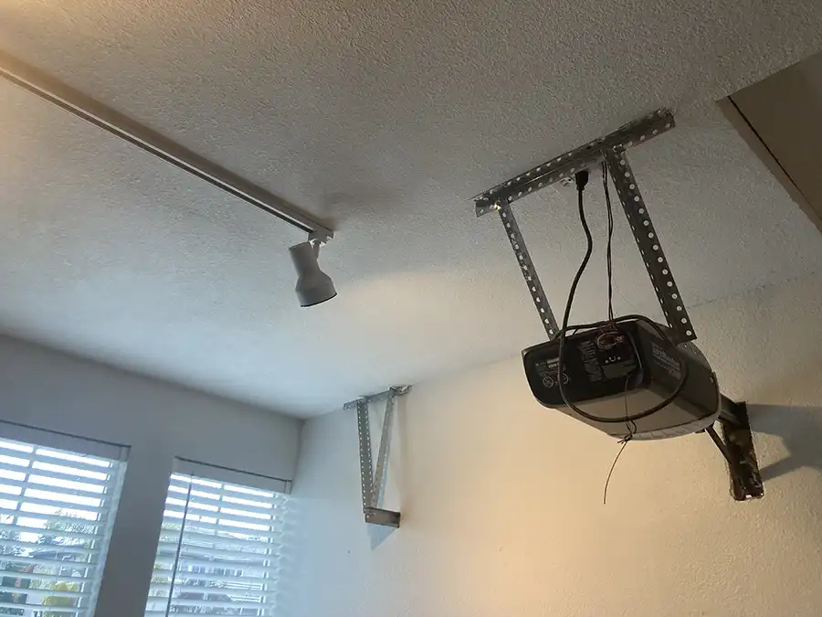 03 BEFORE ARCH IMG_1357 movie projector on textured white ceiling with track lighting