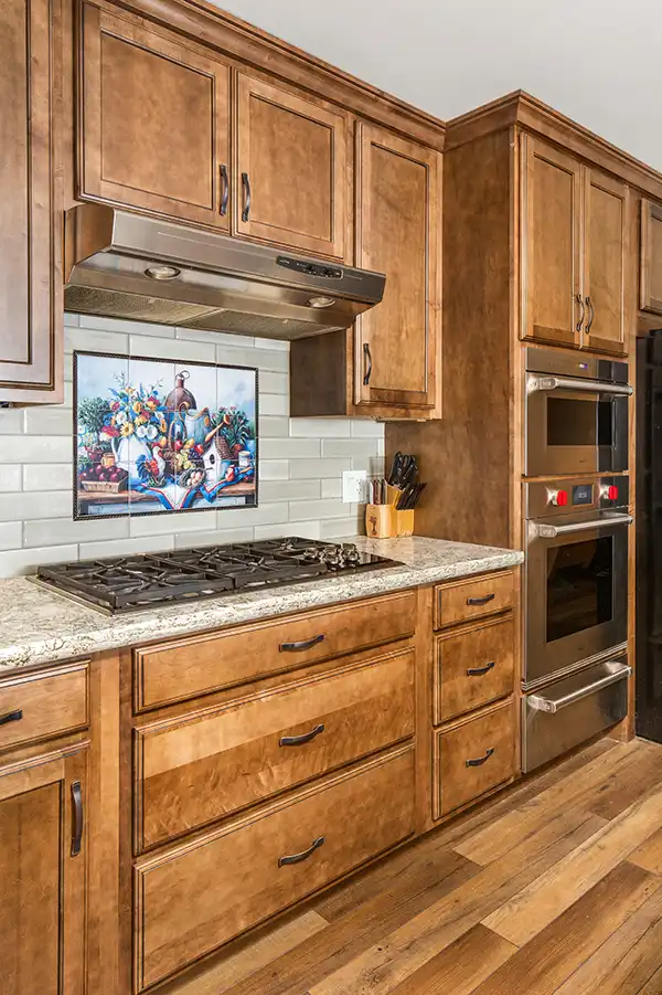 04 YellowoodPl_CareyBros2 Custom cabinetry with a clean, transitional profile, Large center island, Durable quartz or stone countertops with eased edges, Tile backsplash extending to the underside of upper cabinets, Energy-efficient appliances integrated into the cabinetry layout, task and ambient lighting with dimmable controls, Pantry storage