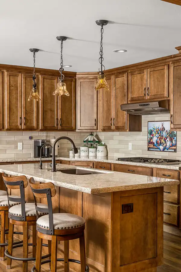 06 YellowoodPl_CareyBros8 Custom cabinetry with a clean, transitional profile, Large center island, Durable quartz or stone countertops with eased edges, Tile backsplash extending to the underside of upper cabinets, Energy-efficient appliances integrated into the cabinetry layout, task and ambient lighting with dimmable controls, Pantry storage